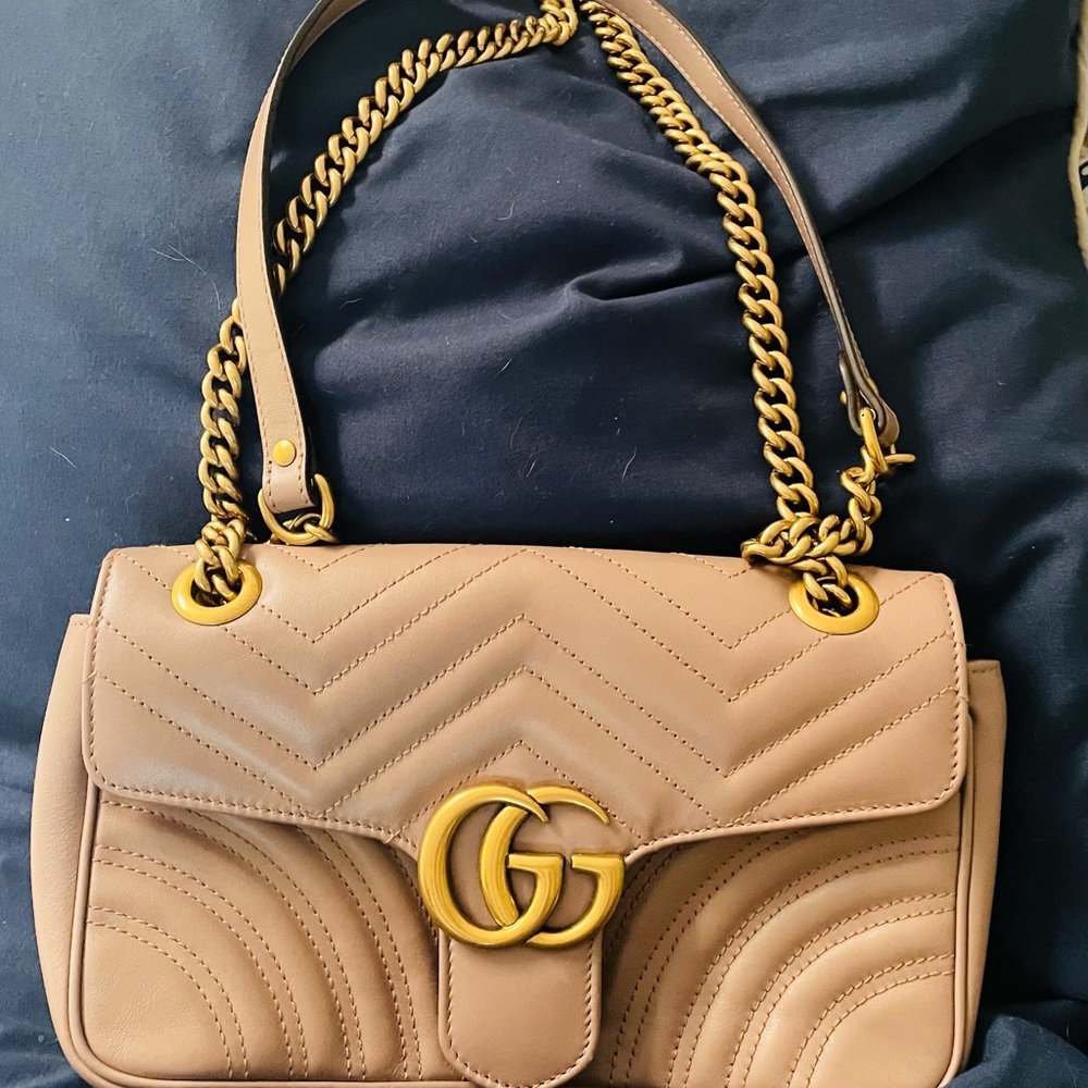 Rose gold Gucci purse.